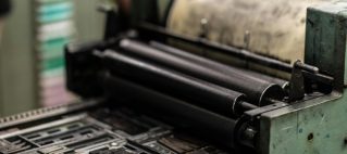 Detailed view of an industrial printing press with precise mechanics.