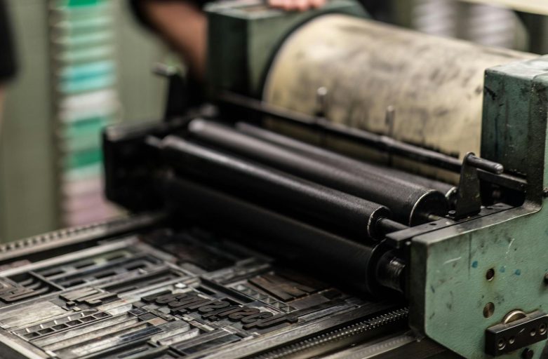 Detailed view of an industrial printing press with precise mechanics.